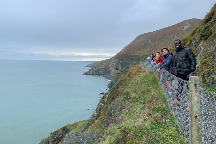 Group of international graduate students studying abroad in Ireland on Bray cliff walk